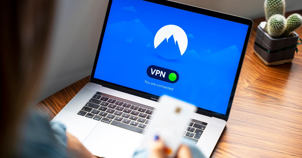 A person using a VPN on a laptop, symbolizing secure internet browsing in a modern indoor setting.